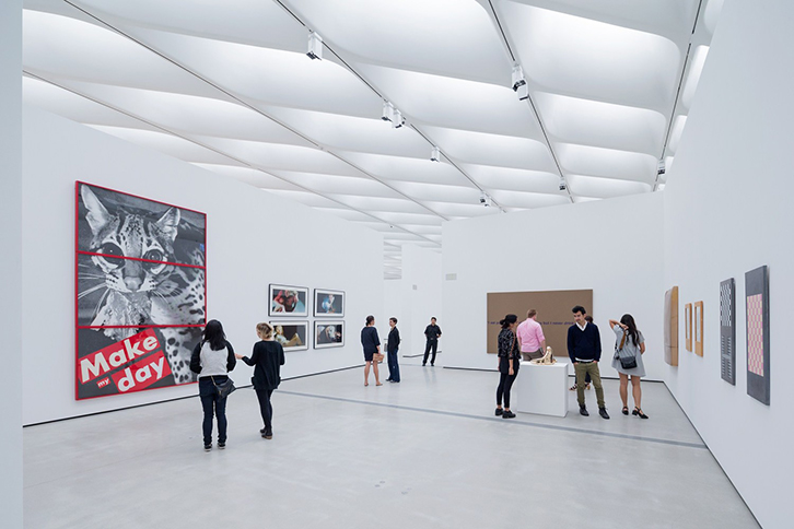 Visitors in large exhibition room view exhibits