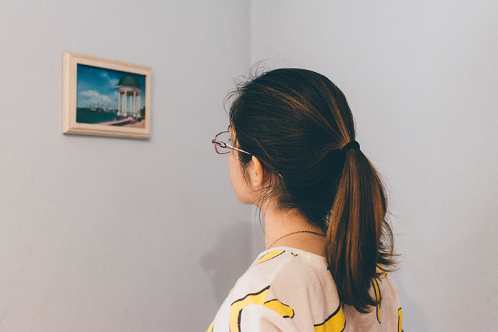 Exhibition visitor in front of a small exhibit