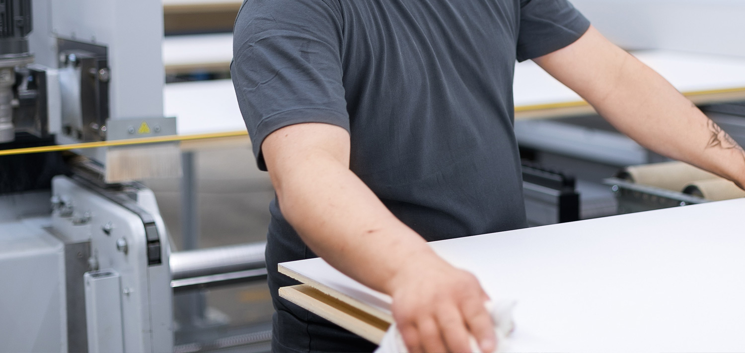 Close-up in the MBA production: employee working on wall module